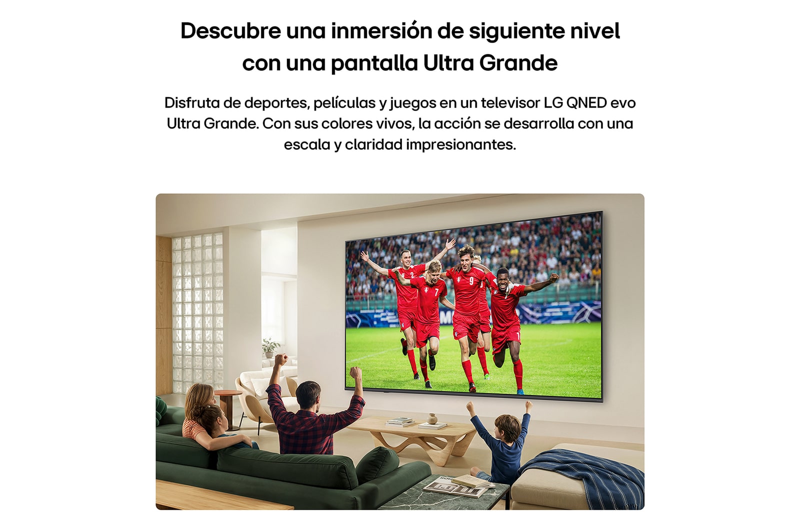 LG QNED AI QNED74 Mini LED Ultra Big TV is wall-mounted in a bright living room, showing an intense soccer moment with vivid colors and refined picture quality across a wide screen, as a family seated on sofas cheers together.